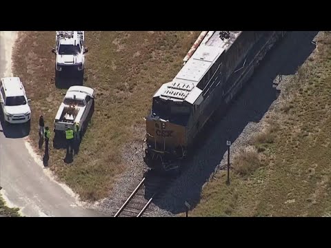 1 dead after dump truck and train collide, burst into flames, Hillsborough officials say